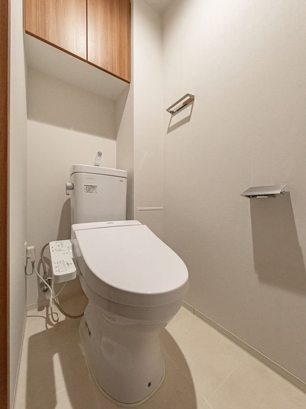 【CASA】 グランドパレス彩都あさぎ 【トイレ】白の壁紙が清潔感を思わせてくれるお手洗いです。扉付きの棚がありますので、掃除道具などもしまっていただけます。